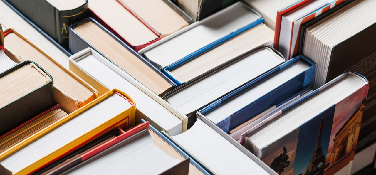 Books Randomly Stacked on the Shelf