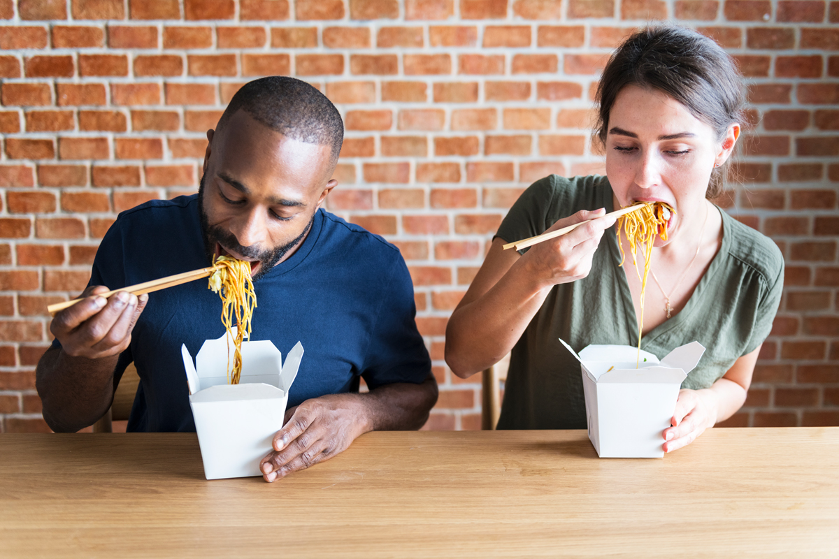 Couple eating Chow mein together.