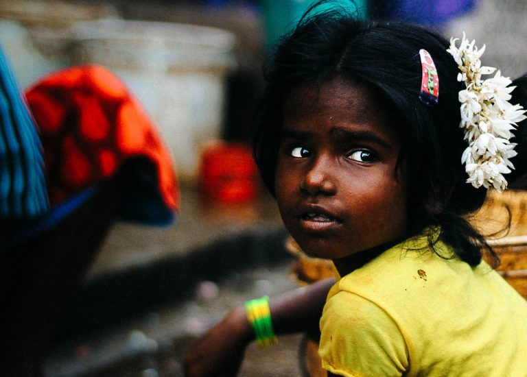 Little girl sitting on a street