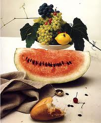 The image combines fresh fruits and a loaf of bread that was tried by a person.