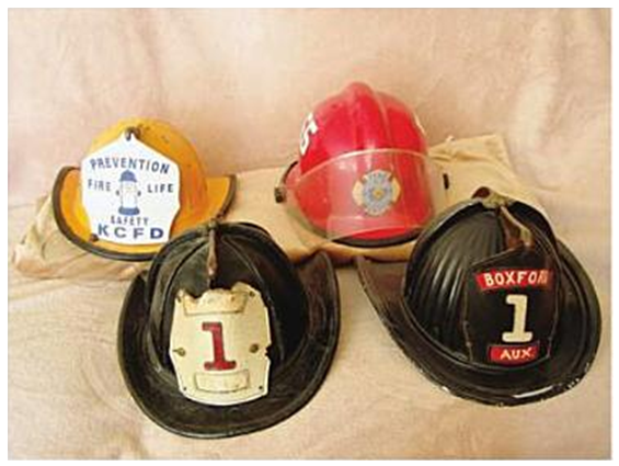 Assortment of fire helmets, including leather, metal, fiberglass and plastic