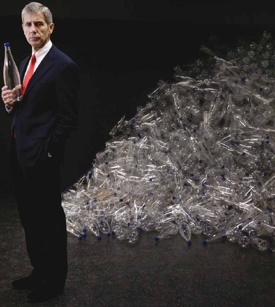 A pensive man near the mountain of plastic bottles