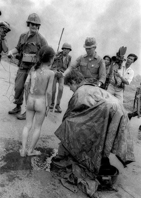 Nick Ut took this image seconds after his famous shot, of Kim Phuc running down the street. Television crews and South Vietnamese troops surround 9-year-old Kim Phuc on Route 1 near Trang Bang, South Vietnam, after she was burned by a misdirected aerial napalm attack, June 8, 1972