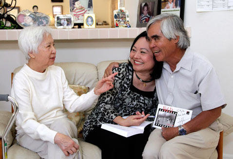 From right, Associated Press staff photographer Nick Ut, Phan Thi Kim Phuc and Dr. My Le, who treated Kim Phuc two days after a napalm attack in Vietnam 40 years ago, sit together during a reunion in Buena Park, Calif., June 2, 2012