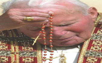 The pope using a rosary for prayers. 