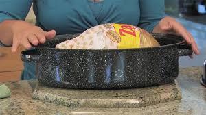 Turkey on rack over a roasting pan.