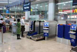Travelers using self-service technology at Melbourne Airport.