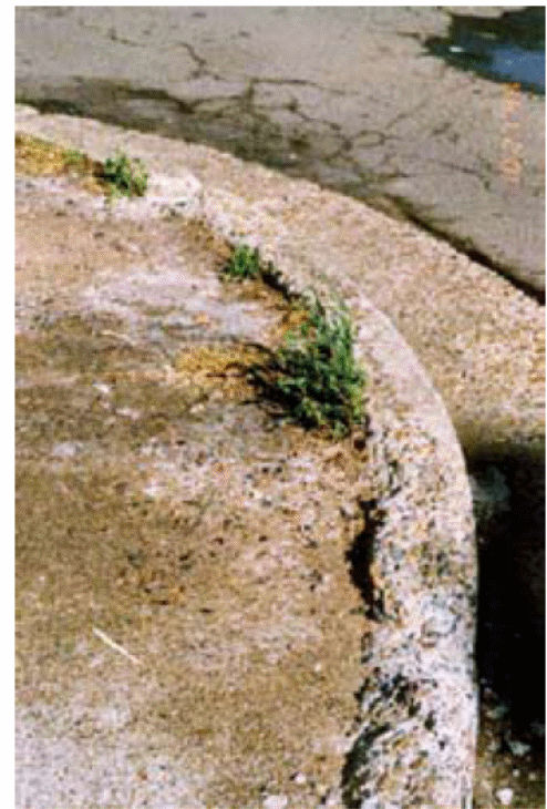 shows Kerb and guttering affected by sulphates.