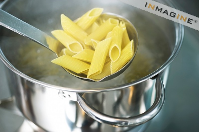 Penne Pasta Being Placed in Hot Water.
