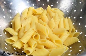 Penne Pasta Being Drained.