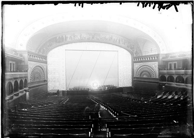 Auditorium Theater, View Looking from the Back of the Theater Over the Rows of Seats on the Main Floor Toward the Curtained Stage (Chicago Daily News, Inc., photographer).
