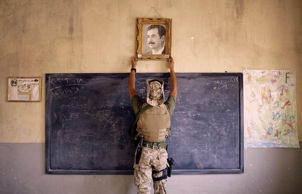 A U.S. Marine Takes Down a Portrait of Saddam Hussein
