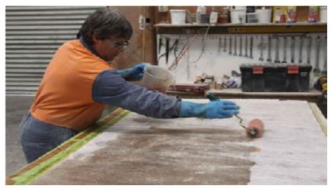 Contact molding: Applying resin to the glass mat reinforcing (CSM)